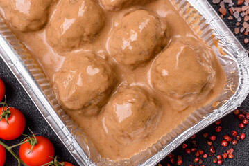Meatballs with salt and spices in creamy caramel sauce