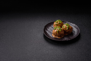 Meatballs with salt and spices in creamy caramel sauce