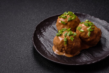 Meatballs with salt and spices in creamy caramel sauce