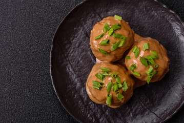 Meatballs with salt and spices in creamy caramel sauce
