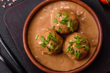 Meatballs with salt and spices in creamy caramel sauce