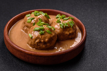 Meatballs with salt and spices in creamy caramel sauce