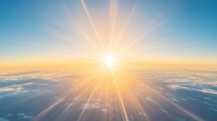 Fototapeta premium Bright sunlight over cloudy horizon creating golden sky at sunrise