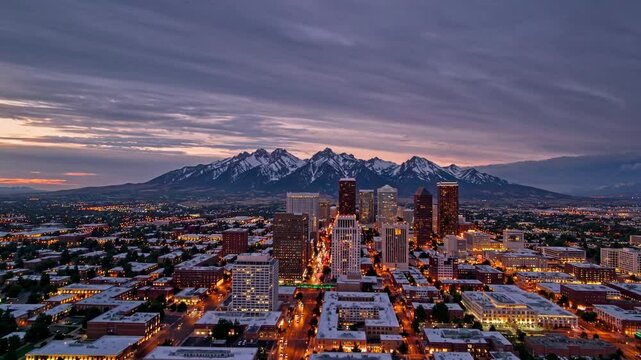 A breathtaking 4K ultra-HD stock video capturing the stunning skyline of Salt Lake City, Utah, at sunset, with the majestic Wasatch Mountains providing a dramatic and picturesque backdrop