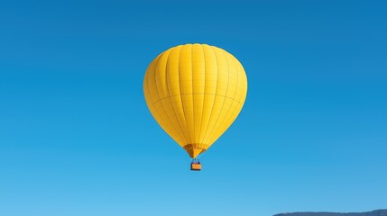 Fototapeta premium Yellow hot air balloon soaring, clear sky, landscape below, travel advertisement