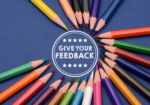 Give Us Your Feedback Sign in circle with colorful pencils