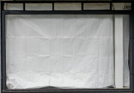 white tarpaulin hanging in a shop front window, closed shop window, detail shot, nice window overlay or effect layer.