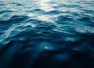 Fototapeta premium A close-up of the calm, undulating surface of water with gentle ripples and reflections. 