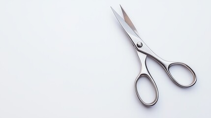 A pair of sharp, stainless steel scissors placed on a clean, white background. Ideal for representing office supplies or crafting tools in various creative projects.