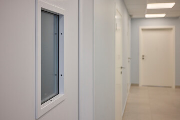 Fototapeta premium A White Door with a Window in a Contemporary Interior, Exuding Elegance and Style