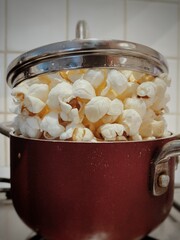 Popcorn in small red pot with lid on top