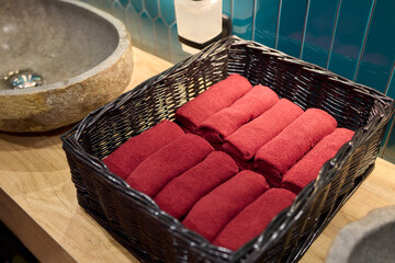Neatly Stacked Red Towels Presenting a Luxurious Spa Setting for Relaxation and Comfort