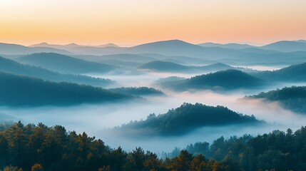 Fototapeta premium Serene Morning Mist Envelops Rolling Hills Under a Colorful Sunrise in a Tranquil Mountain Region