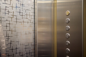 The modern elevator control panel features a display showcasing the current floor number