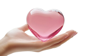 Obraz premium A delicate hand gently cradles a translucent pink heart-shaped glass piece, reflecting soft light. The scene evokes feelings of love and tenderness, radiating calm energy