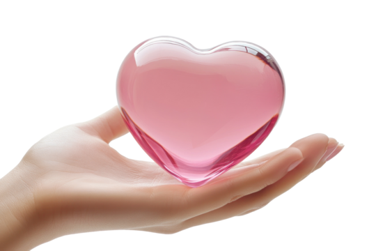 A delicate hand gently cradles a translucent pink heart-shaped glass piece, reflecting soft light. The scene evokes feelings of love and tenderness, radiating calm energy