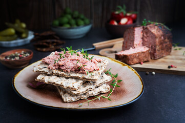 Liver pate spread on crispbread, placed on a plate, ready to serve as an appetizer.