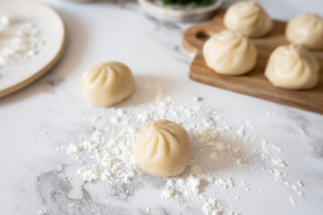 Handmade raw dumplings, lightly dusted with flour.