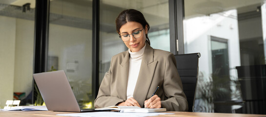 Professional financial specialist business lady working concentrated on laptop pc in office. Middle...
