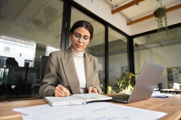 Focused professional latin hispanic financial specialist business lady working concentrated on...