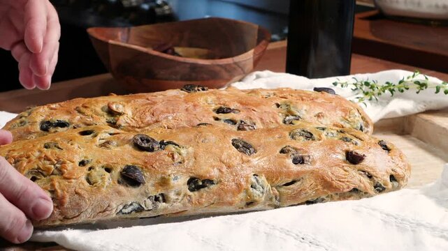 Baking three olive bread filled with different types of olives. Baking bread with ingredients like flour, yeast, salt, water and sugar.  Fresh baked rustic bread. 