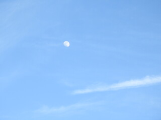 A waxing gibbous moon, visible within a daytime sky, over Dorchester County, Maryland.