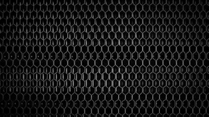 A black and white photo of a metal mesh with a black background. The photo is of a close up of the mesh, with the holes and the pattern of the mesh visible. The photo has a moody