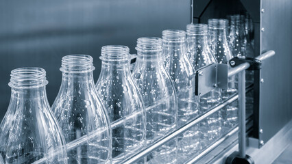 Bottle. Industrial production of plastic pet bottles. Factory line for manufacturing polyethylene bottles. Transparent food packaging.