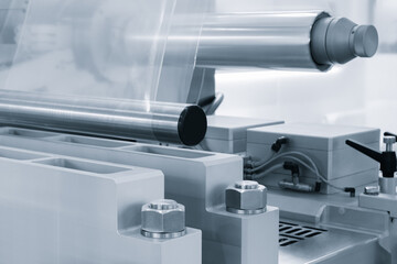 Industrial machine for production and printing of polyethylene bags. Industrial concept background