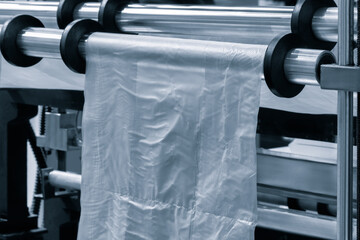 Industrial machine for production and printing of polyethylene bags. Industrial concept background