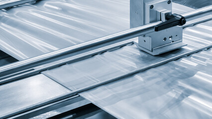 Industrial machine for production and printing of polyethylene bags. Industrial concept background