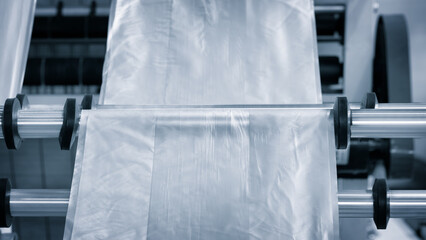 Industrial machine for production and printing of polyethylene bags. Industrial concept background