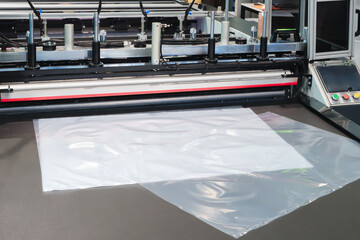 Industrial machine for production and printing of polyethylene bags. Industrial concept background