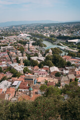 Fototapeta premium Panoramic view of an old city with historic architecture and modern buildings. Tbilisi, Georgia