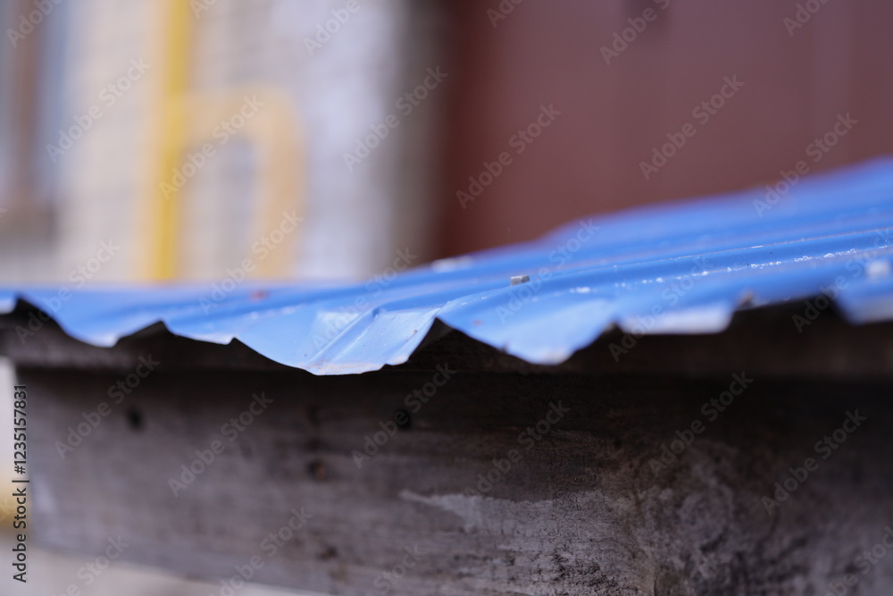 Aufkleber close-up shot of a metal roof on a building with sharp edges and rivets.
