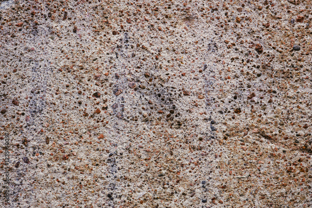Aufkleber close-up view of a stone surface featuring small rocks and texture.