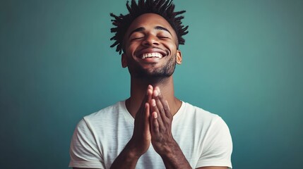 Man expresses joy and gratitude while smiling in a relaxed indoor setting