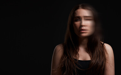 Woman, portrait and blur in studio for mental health, identity crisis or bipolar disorder. Psychology, person or sad on black background space with facial distortion, dissociation or PTSD with trauma
