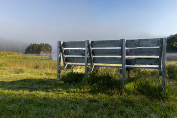 Bench next to lake in the haze
