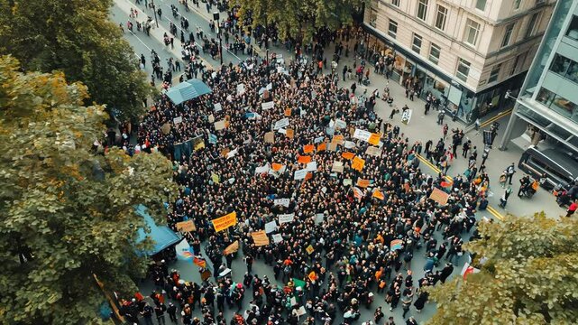Large crowds fill the city streets rallying for social justice with colorful signs and passionate calls for change during a lively event