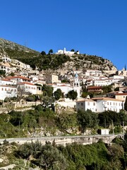 Fototapeta premium A picturesque panoramic view of Dhermi, Albania, capturing the charm of its rural countryside, traditional village life, and the beauty of the Mediterranean landscape.