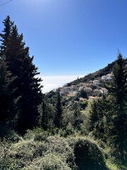 Obraz premium A picturesque panoramic view of Dhermi, Albania, capturing the charm of its rural countryside, traditional village life, and the beauty of the Mediterranean landscape.