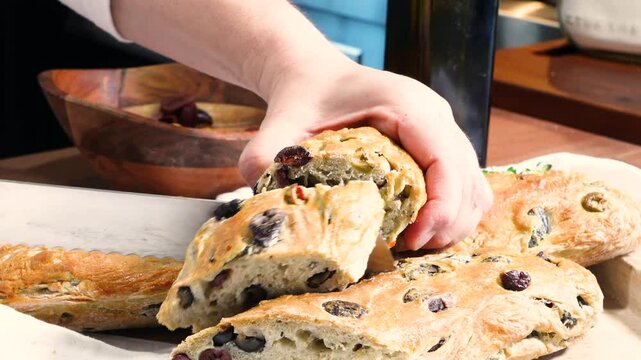 Baking three olive bread filled with different types of olives. Baking bread with ingredients like flour, yeast, salt, water and sugar.  Fresh baked rustic bread. 