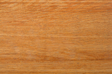 Naklejka premium A close-up shot of a textured, light brown wooden surface with a visible grain