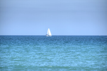 Tropical Ocean Sailboat with Blue Sky’s and Water.