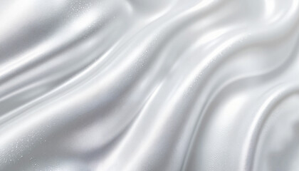 Fluid metallic silver swirls on smooth fabric, artistic abstraction