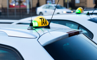 close up on taxi sign on car in the city