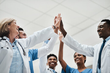 Hands together, doctor or nurse high five in hospital for good news, goals or teamwork achievement....