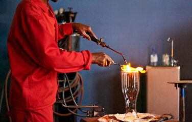 Glassblowing, heat and man with blowtorch, shaping and creative for manufacturing of glass and...