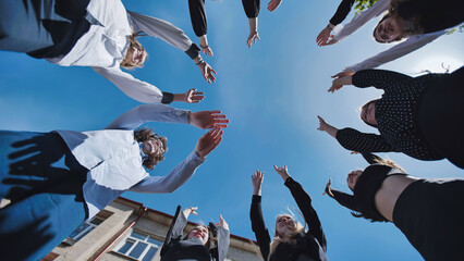 Joyful students in the schoolyard, joining hands in a circle to celebrate friendship and unity